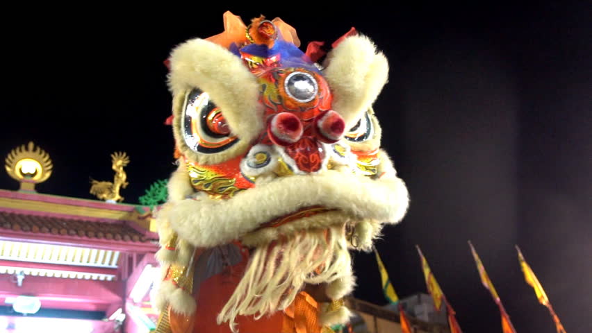 Chinese lion dancers performing during the Lunar New Year celebration in Chinatown. Royalty-Free Stock Footage #1019165542