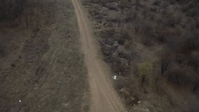 Backward flight over mud road aerial 4K video