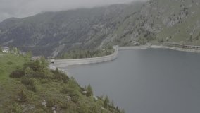 Aerial Drone footage view of Fedaia Dam in Dolomites in Italy // no video editing
