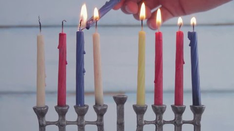 Hanukkah scene. Lighting up candels on menorah