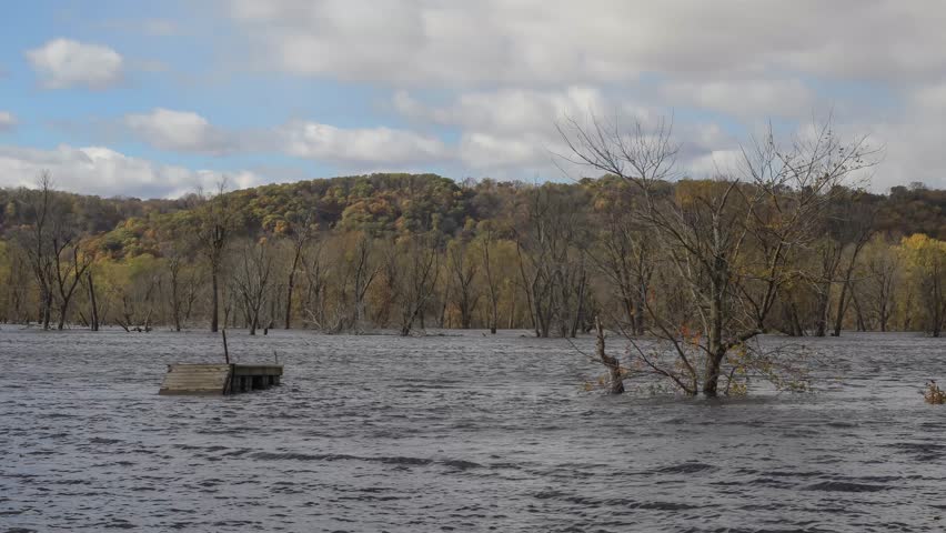 A Medium Daytime Shot of Clouds Rolling over the Flooded Mississippi River during Late Autumn in Wylausing State Park 4K Timelapse