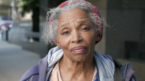 Portrait of emotional African American homeless woman looking in camera dejected.  Could also be used as a piece for immigration.