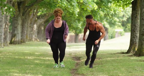 4K Fitness coach working out with obese woman, giving motivation & encouragement