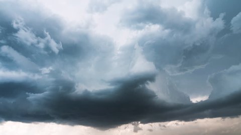 Time lapse of clouds rolling and spiraling in the sky during storm in dramatic form.