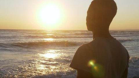 Migration,refugee,Homeland. Sad black man looking the sea at sunset