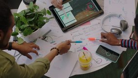 close up hands young engineers developing fitness app software using digital tablet computer brainstorming design solution sharing ideas in startup office meeting top view - Powered by Shutterstock - Get 15% off with code: PIKWIZARD15