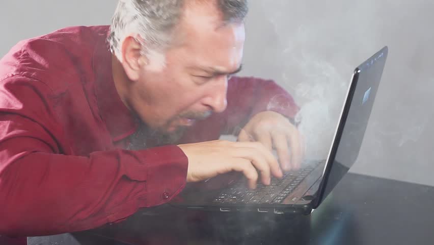 Crazy fanatical businessman working on a burning computer. Accountant report. Cryptocurrencies. Royalty-Free Stock Footage #1019226028