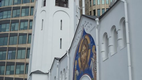 Icon of Jesus Christ on the background of the financial quarter in Moscow. Dolly Shot
