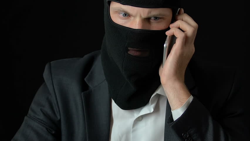 Rich criminal in balaclava answering phone call, illegal business, blackmail | Shutterstock HD Video #1019231497