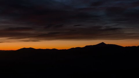 4k footage of Sunrise timelapse in mountains with colourful clouds. Majestic mountain landscape with colorful cloud. Dramatic sky.