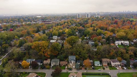 Aerial shot of city park and suburban neighbourhood at Scarborough Bluffs during peak fall colors.