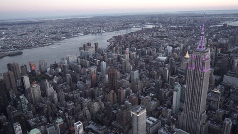 New York City Circa-2015, aerial view of Midtown Manhattan and East River at dusk flying by Empire State Building