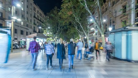 Fast walking on La Rambla street in Barcelona night timelapse hyperlapse, Spain. Thousands of people walk daily by this popular pedestrian area. Crowded place