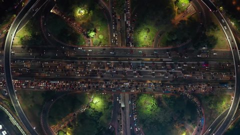 Top down view of traffic jam during rush hour at night on Semanggi highway interchange in Jakarta city, Indonesia. Shot in 4k resolution