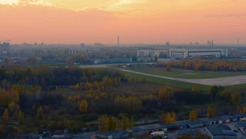 Aerial view of an air cargo terminal with runway at sunset