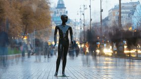 The black dummy standing on the street with people. time lapse