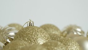 Shiny golden Christmas baubles shallow DOF 4K tilting video