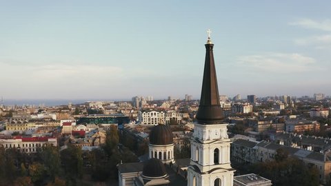 Aerial drone rotation around the spire of Preobrazhensky Cathedral Odessa during sunset