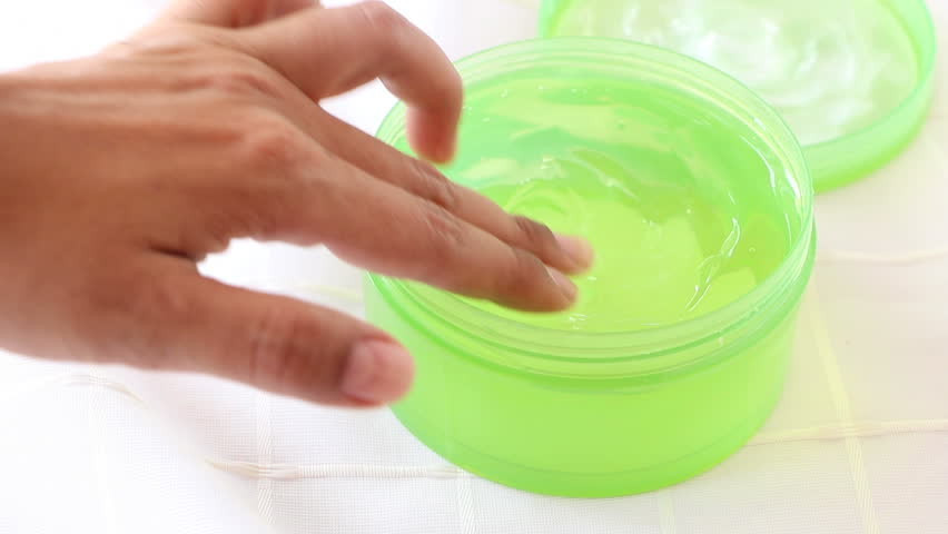 Closeup open gel aloe vera moisturizer transparent cream in green container on white fabric background, woman use finger applying it by whirl and pat, side view have copy space, concept cosmetic | Shutterstock HD Video #1019268964