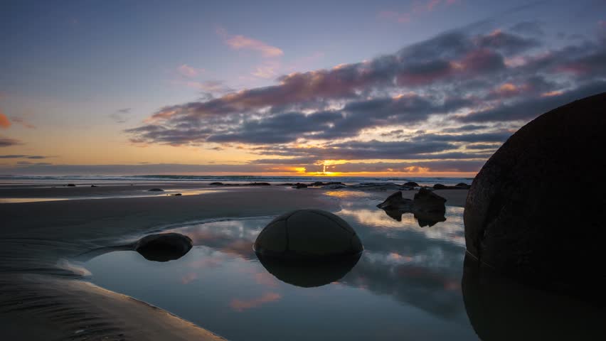 Beautiful Sunrise At Moeraki Boulders- Timelapse With Brush Stroke Effect.
Moeraki Boulders are a group of large spherical stones exposed by shoreline erosion on Koekohe Beach near Moeraki.