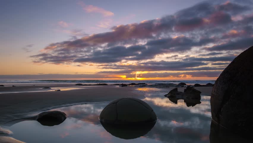 Beautiful Sunrise At Moeraki Boulders- Timelapse With Short Brush Stroke Effect.
Moeraki Boulders are a group of large spherical stones exposed by shoreline erosion on Koekohe Beach near Moeraki.