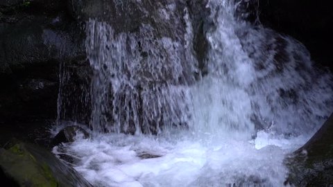 Waterfall in mountains in slow motion. Shot of a natural waterfall near Batumi, Georgia, close up 