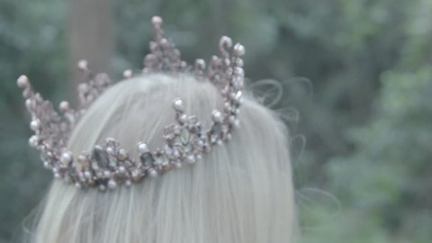 Princess and queen with crowns in royal enchanted forest