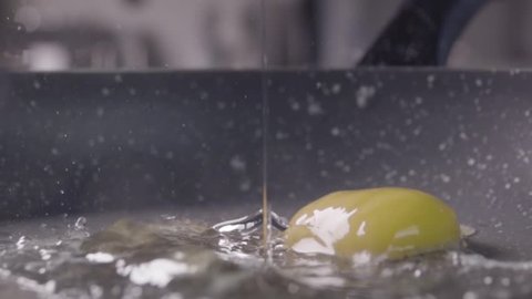 Falling of the egg into the frying pan. Slow motion