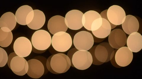HD Footage of Blinking yellow bokeh lights moving fast and slow.