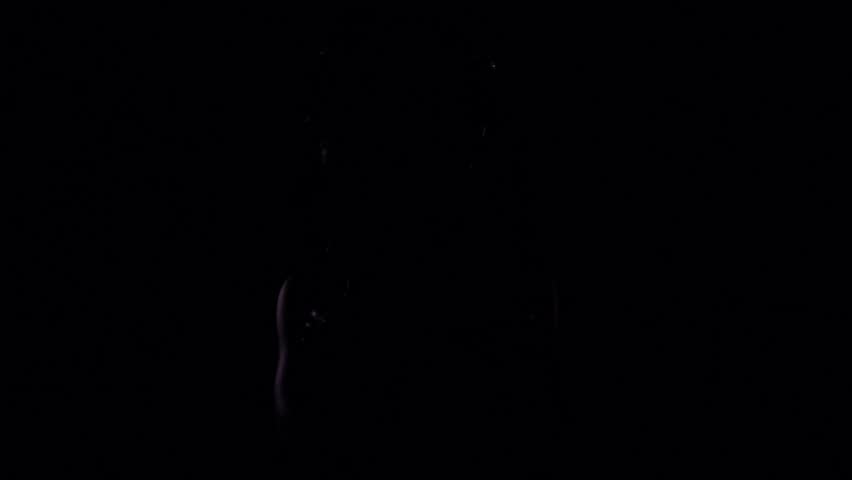 Medusa Gorgon appears from the dark with her arms crossed, black background