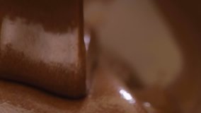 Slow motion of pouring melted chocolate.