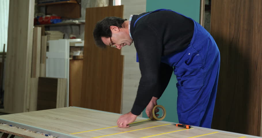 Carpenter Builder Man Work Expand a Scotch Tape on Furniture in Carpentry Shop | Shutterstock HD Video #1019300929