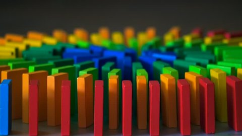 The domino effect of colorful wooden blocks, slow motion, selective focus