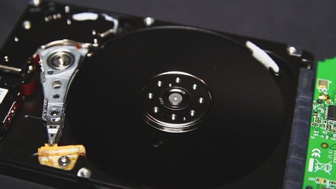 Computer hard disk, hdd. Head and hard drive spindle close-up. Technology of information storage. Arrays of data, servers. innovative technologies. Storage and transmission of information