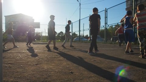 Children Training Playing Football In Ghetto. Authentic video real people kids play soccer outdoor. Football game on ghetto streets. 