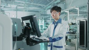 On High Tech Factory Asian Engineer Uses Computer for Programming Pick and Place Surface Mount Electronic Machinery for Printed Circuit Board Assembly Line.Shot on 4K (UHD) Camera - Powered by Shutterstock - Get 15% off with code: PIKWIZARD15