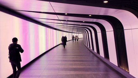 LONDON - OCTOBER 31, 2018: People walking in modern city tunnel in King's Cross London