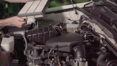 car mechanic checking the car engine oil and air filter inspection for troubleshooting and repair in the garage or car repair shop.4k,30fps.