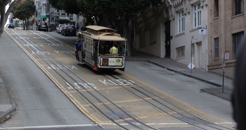 SAN FRANCISCO, USA - APRIL 13, 2013 Cars Traffic and Cable Car Transport People Commuters Commuting in San Francisco