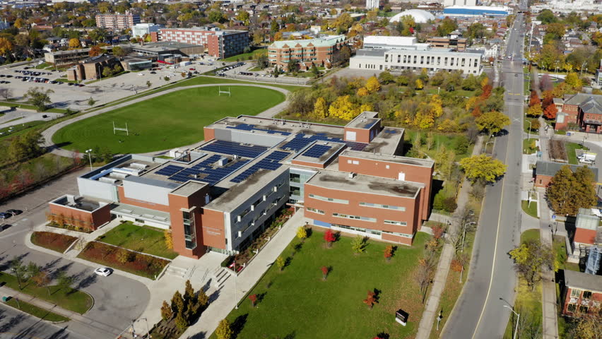 Aerial shot of college athletic center and track field during fall colors.   Royalty-Free Stock Footage #1019317426