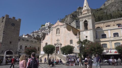 TAORMINA, SICILY/ITALY - SEPTEMBER 26, 2018: Piazza IX April square, San Giuseppe church and Clock Tower, Taormina, Sicily. Taormina, Messina has been a tourist destination since the 19th century.