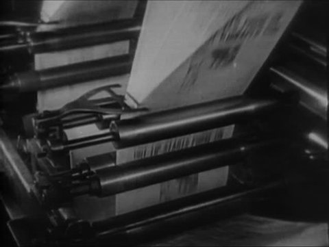Newspapers rolling on printing press conveyor belt, 1930s