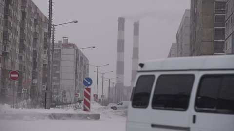 Industrial zone with a large red and white pipe thick white smoke is poured Norilsk 2018