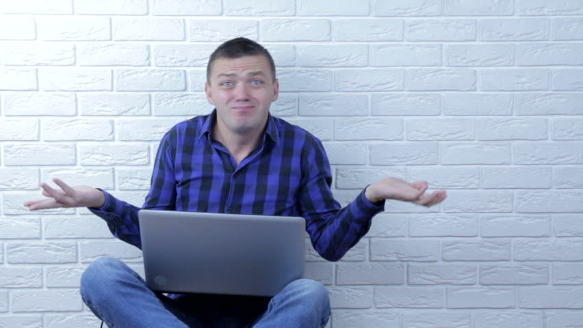 Young man throws up his hands.He is surprised. He does not understand what is happening Royalty-Free Stock Footage #1019337307