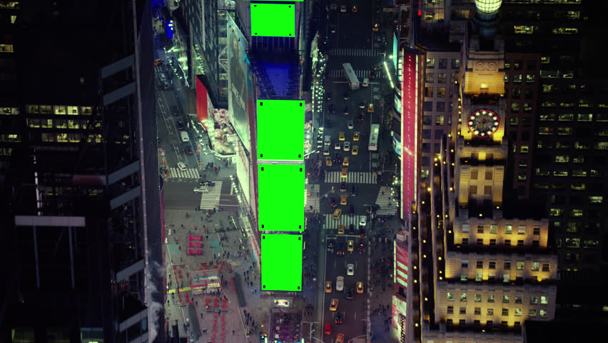 Aerial view of buildings and nightlife in Times Square in downtown Manhattan, New York City, bright night lighting. Wide shot on 4k RED camera with green screens.
