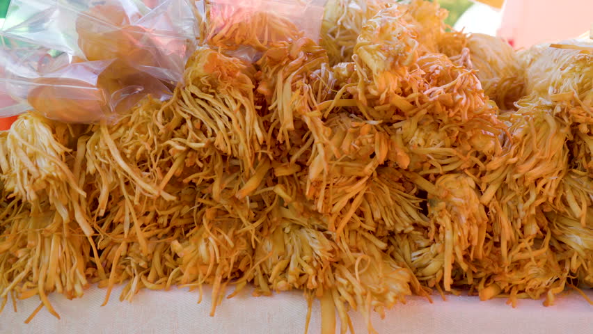 Bread strips being piled up on the table outside of the tent in the bazaar food fair