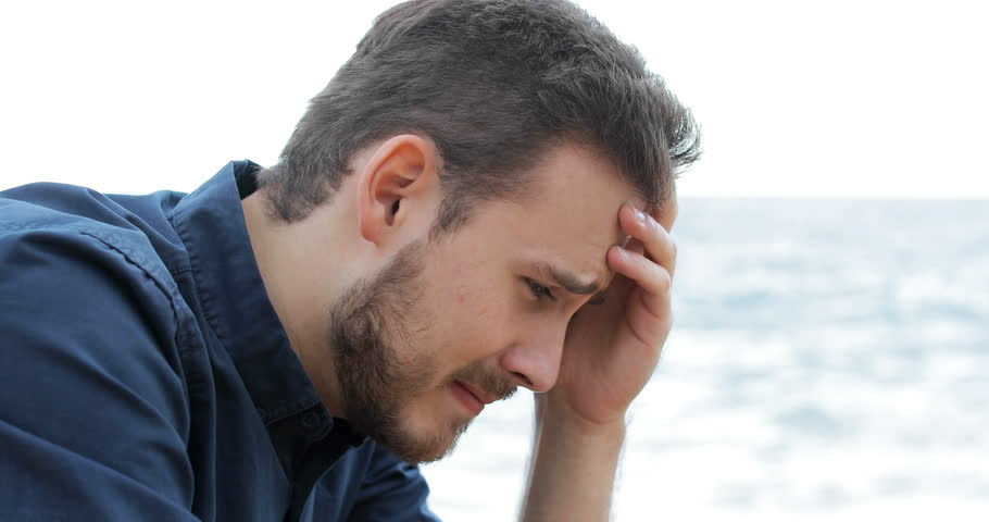 Portrait of a sad man crying on the beach | Shutterstock HD Video #1019341237