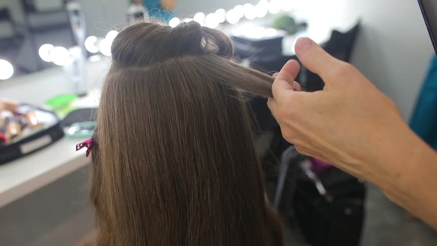 Long natural hair curling ironing 
before celebrating religious adulthood twelve years old girl with family and friends. 
Bat Mitzvah party concept. Royalty-Free Stock Footage #1019342101