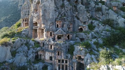 Aerial view of rock-cut tombs of the ancient Lycian necropolis on the cliff in Myra, Demre, Turkey