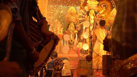 KOLKATA , INDIA - SEPTEMBER 27, 2017 : Young Dhaakis (drummers) performing for Durga Aarti - Goddess Durga worship ritual. - shot at night under colored light. Biggest festival of Hinduism.